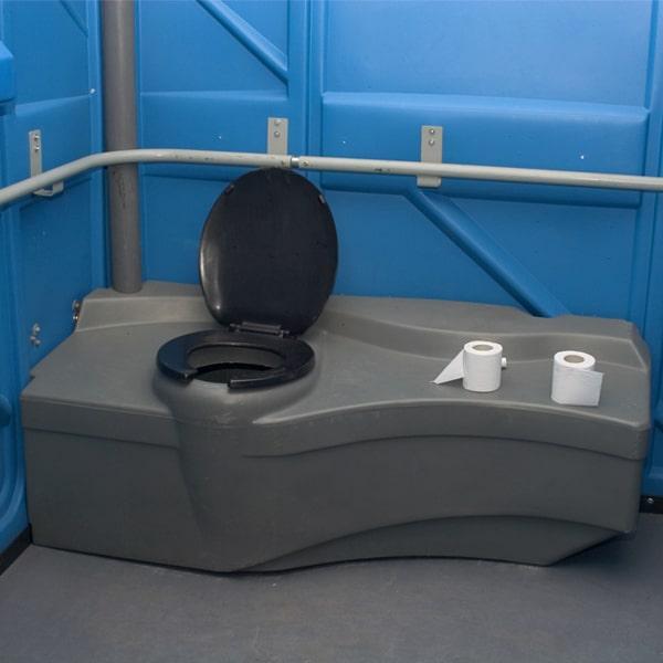 ADA-accessible restroom unit with ramp entry